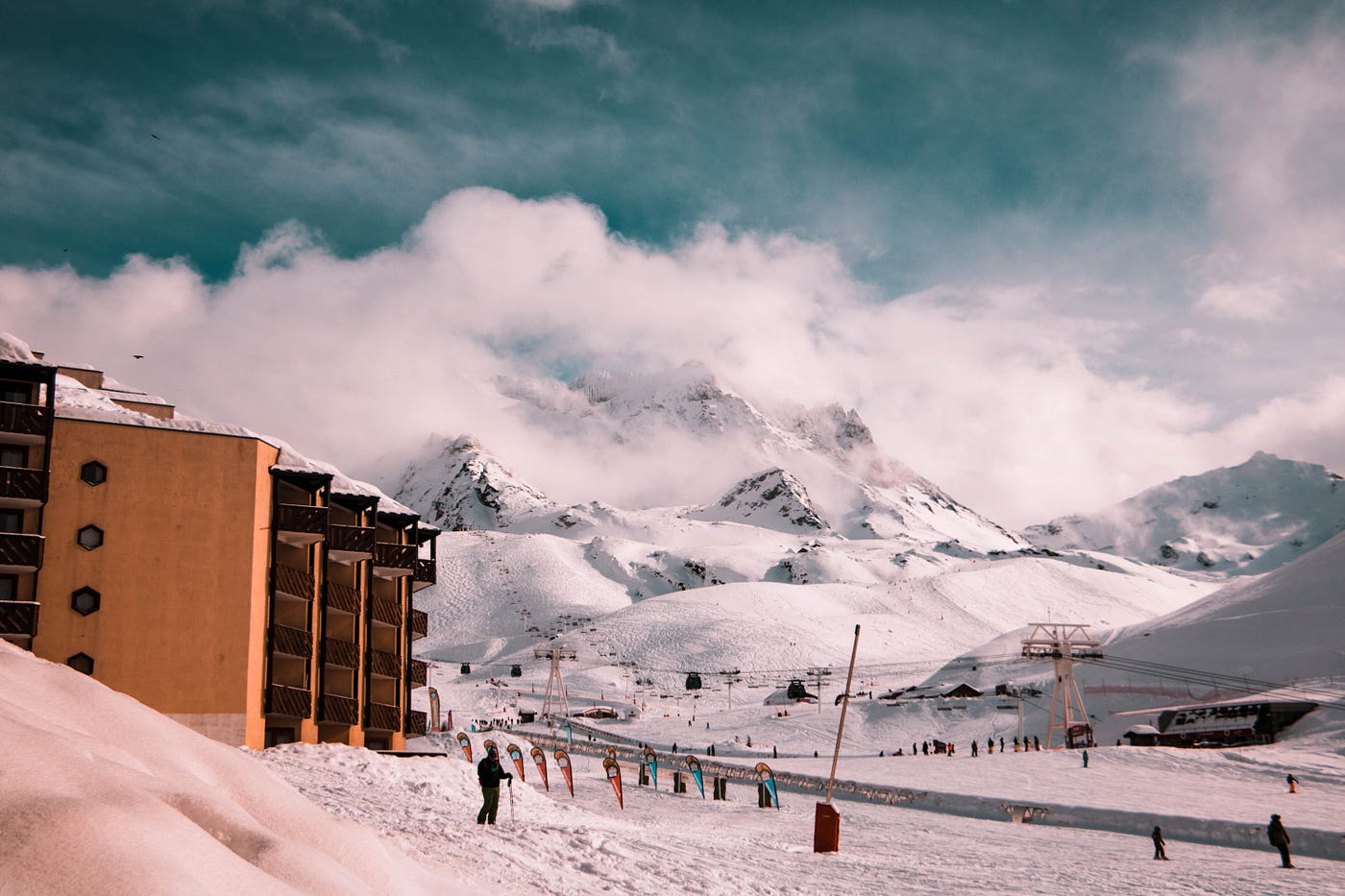 Outside a ski lodge and the ski mountain behind it.