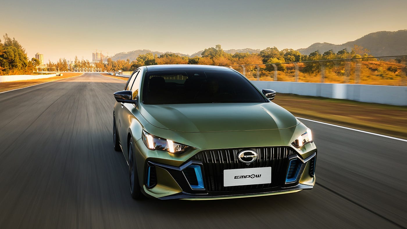 green car driving on a road