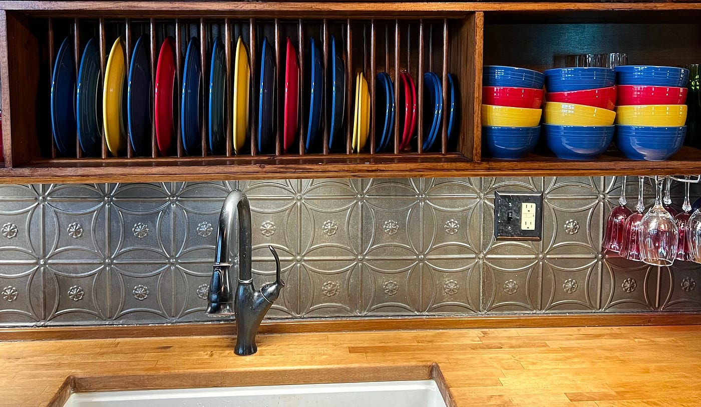 We made many of the cabinets including the plate rail. We chose butcher block partly because we could cut and install it ourselves. The backsplash comes from a tin ceiling we salvaged from the newspaper where I used to serve as editor. For more about our unique kitchen project, click here. (Photo by Michelle Teheux)