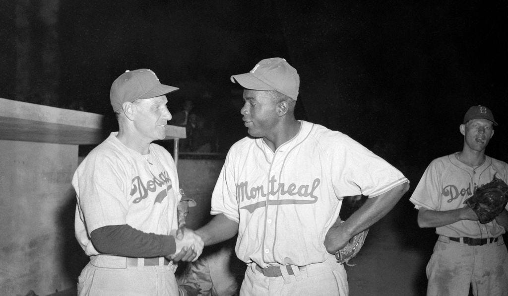 Brooklyn Dodger manager Leo Durocher shakes hands with Jackie Robinson then  with the Dodgers minor league team the Montreal Royals before being called  up to the Major Leagues in 1947 Stock Photo 