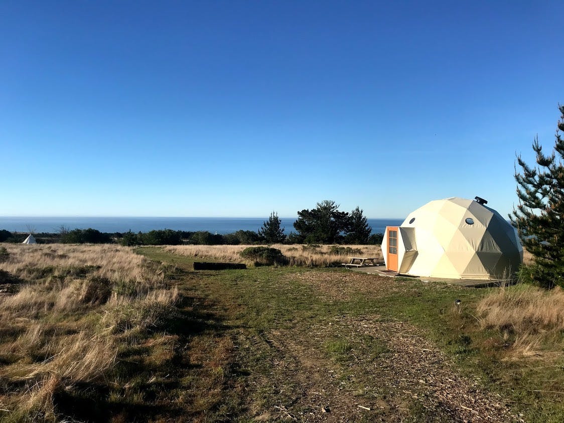 A white geodesic dome near the ocean.