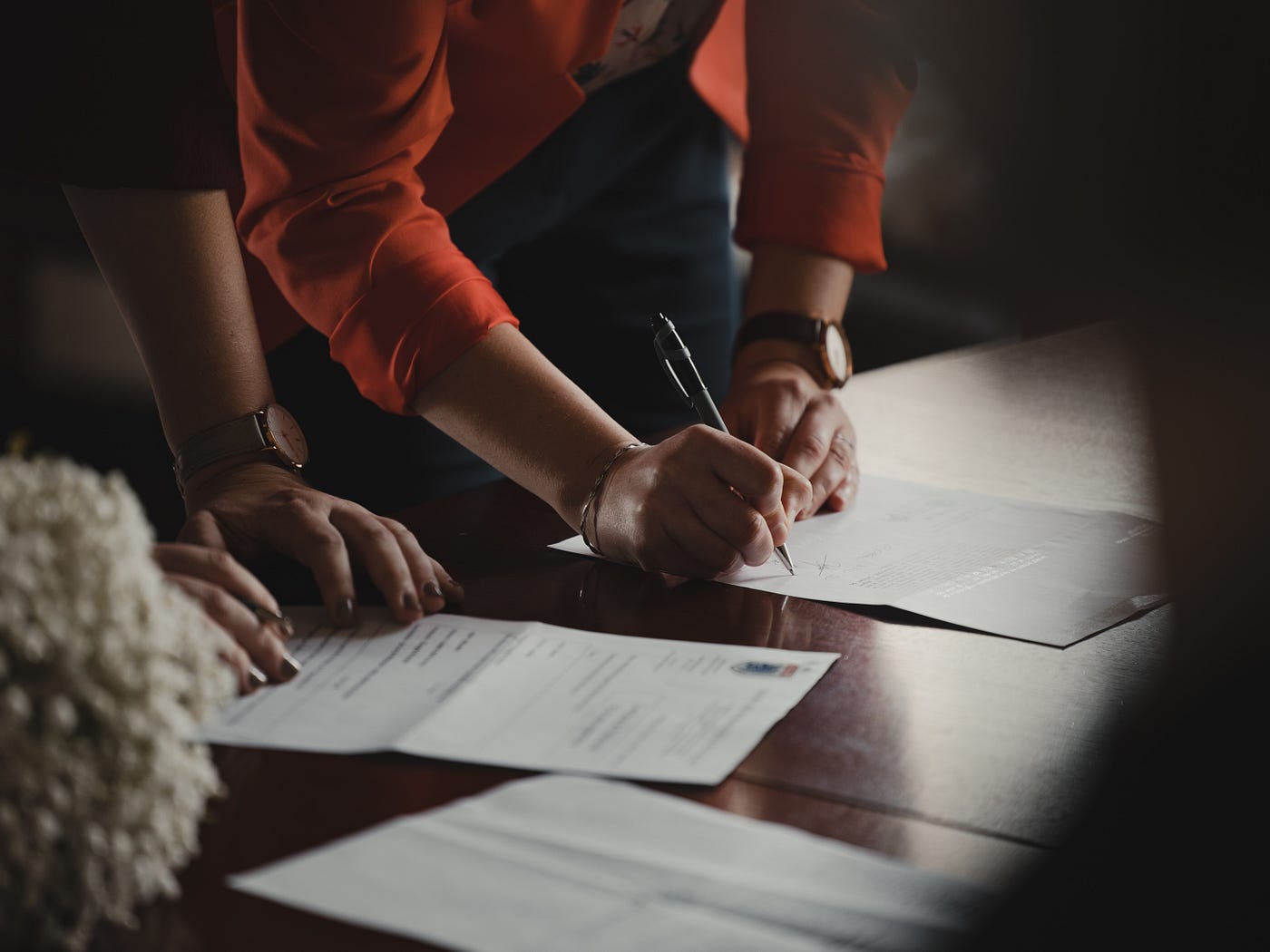 Two people making changes in their printed resume