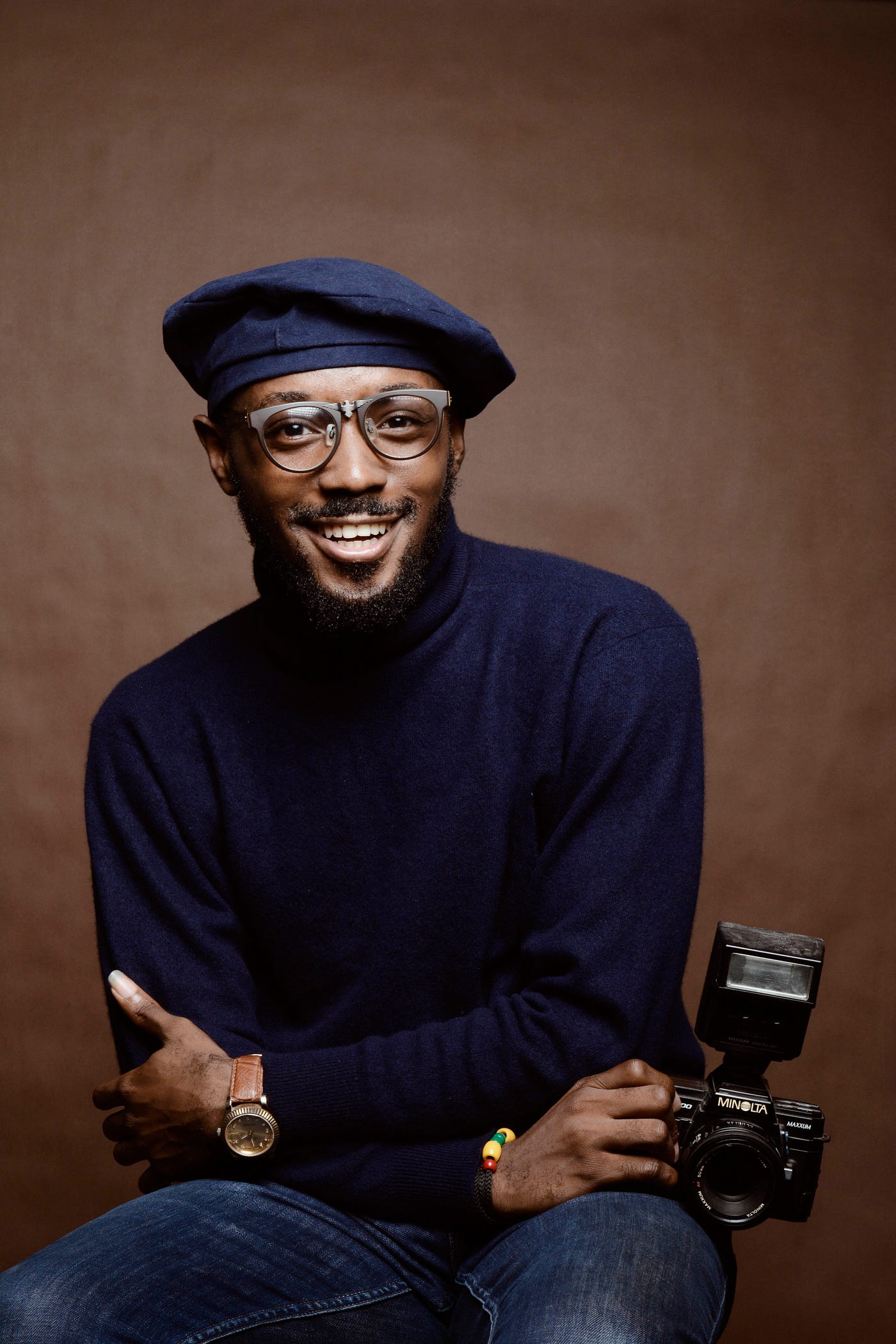 A middle-aged black man smiles at us. He wears a hat, glasses, and a dark blue turtleneck. African American men have a higher prostate cancer risk and should talk to their healthcare professionals about screening at age 45. Prostate cancer screening includes a blood test known as a PSA (prostate specific antigen).
