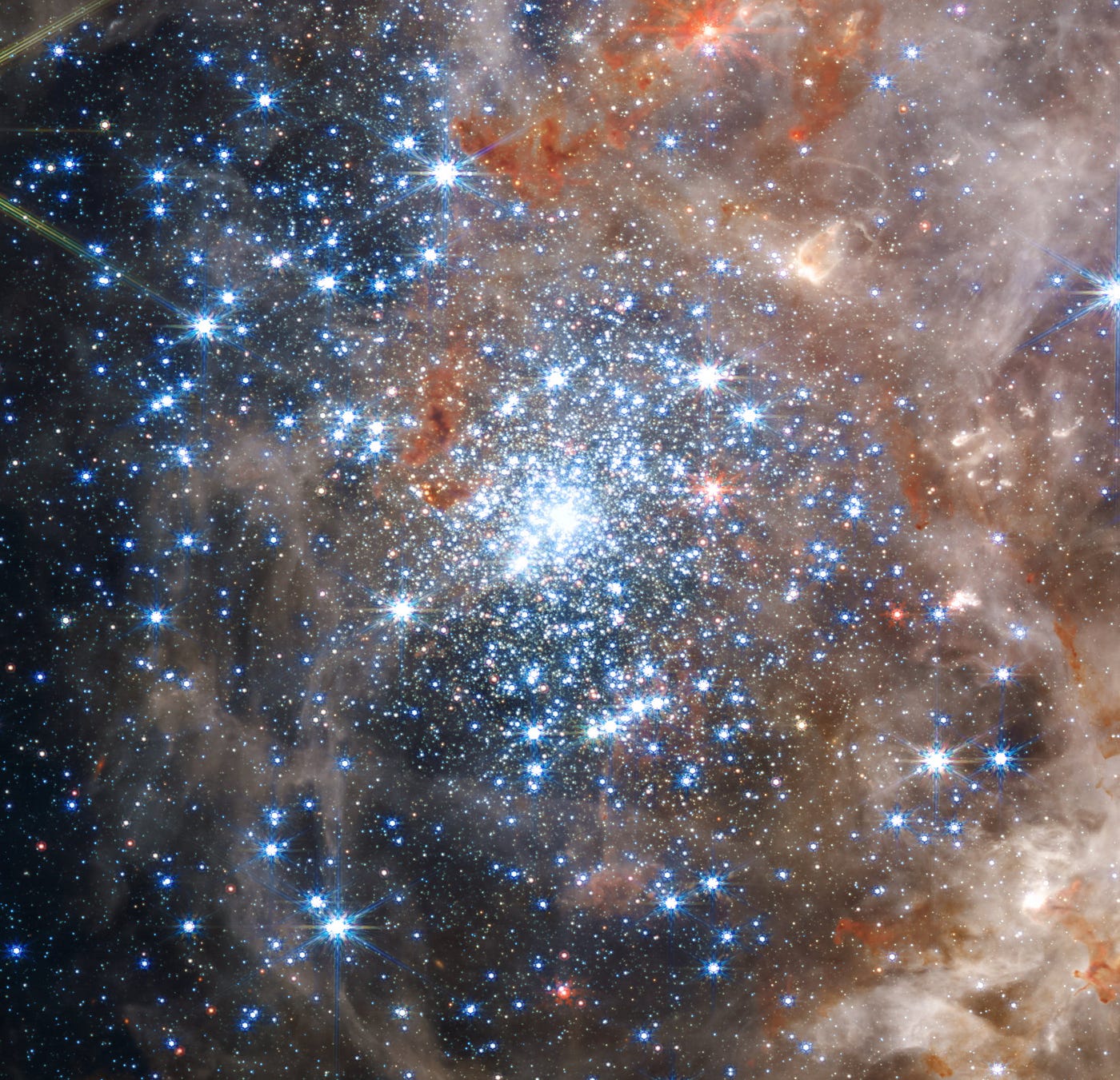 The image shows the central region of the Tarantula Nebula in the Large Magellanic Cloud. The young and dense star cluster R136 can be seen near the center of the image. The tidal forces exerted on the Large Magellanic Cloud by the Milky Way are triggering a wave of star-formation in there, which happens to be the largest star-forming region known in the Local Group. R136a1, at the cluster’s center, is the most massive single star known, with approximately 260 times the mass of our Sun. (Credit: NASA, ESA, CSA, STScI, Webb ERO Production Team)