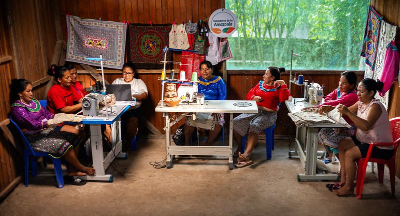 Eight Shipibo-Conibo women work at sewing machines in the Sanken Beka production space near Ucayali, Peru.