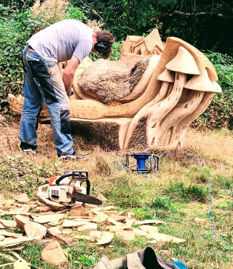 Image of an artist creating sculptures from trees, to illustrate post