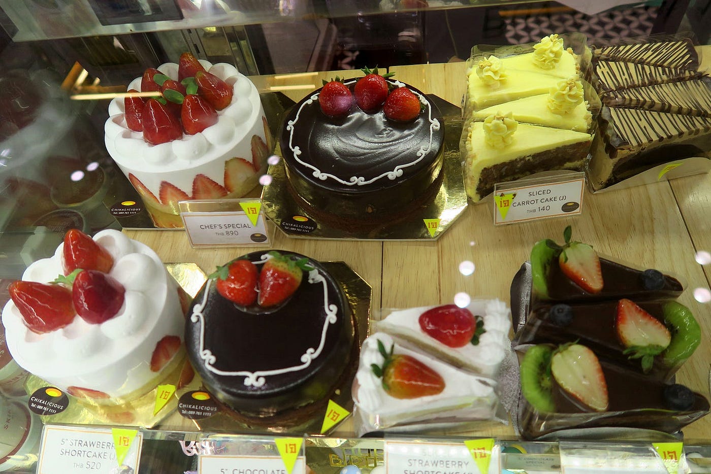 An assortment of decadent vegan cake on display at a bakery in Bangkok.