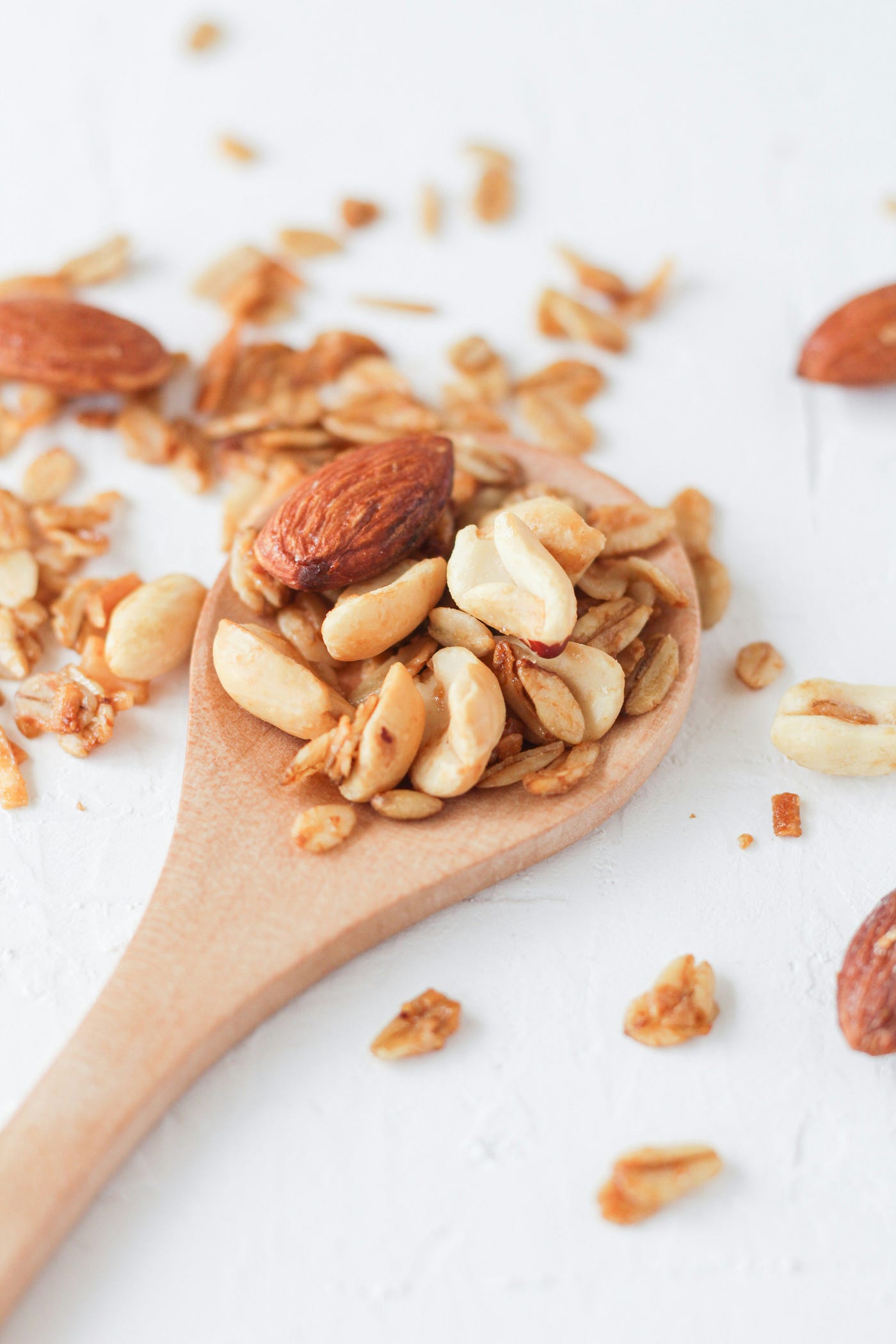 Almonds on a wooden spoon. The Atlantic diet includes nuts.
