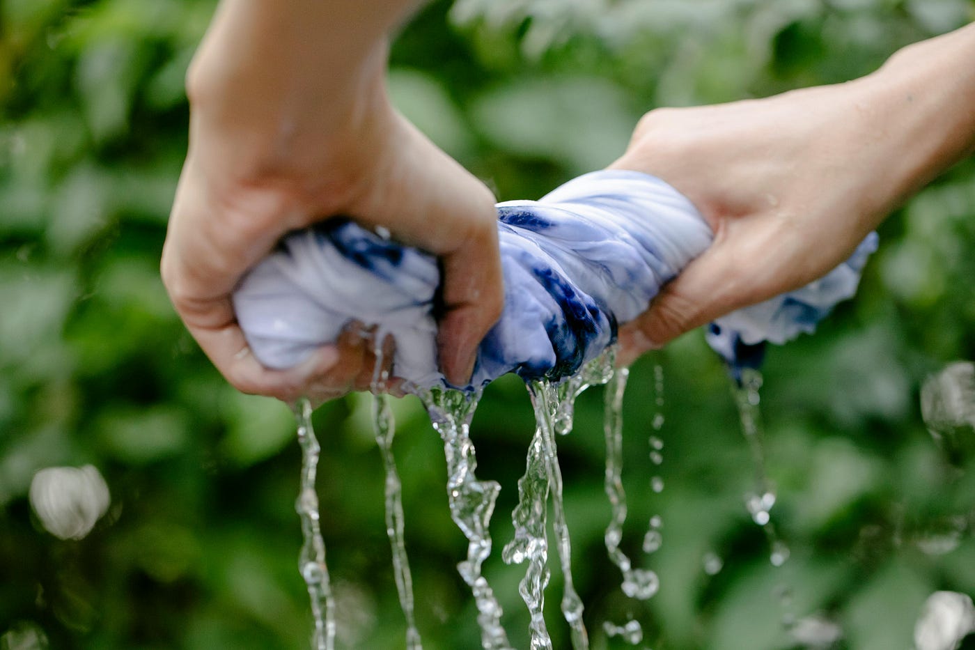 https://www.pexels.com/photo/crop-person-squeezing-colorful-textile-6850541/
