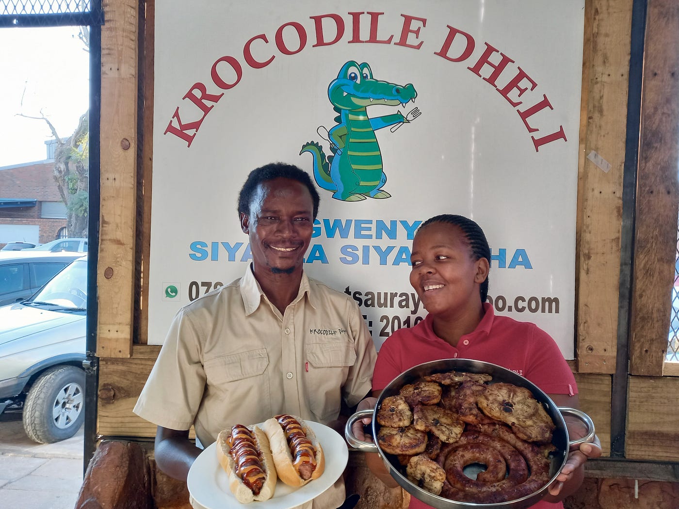 Raphael Tsaurayi and Nomthandazo Mkhize with assorted crocodile delights at his small-house ‘krok’ shisanyama cum butchery. (Photo: Wanda Hennig)