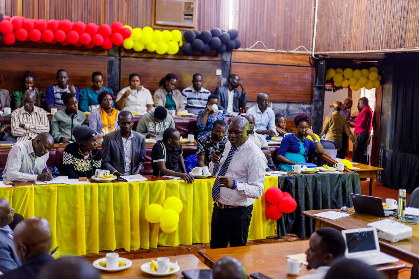 Mr. Kiwanuka Shimoni, the Regional Support Centre Liaison Officer for the Butambala Cluster, giving a presentation on the overview of CBFs and PTCs
