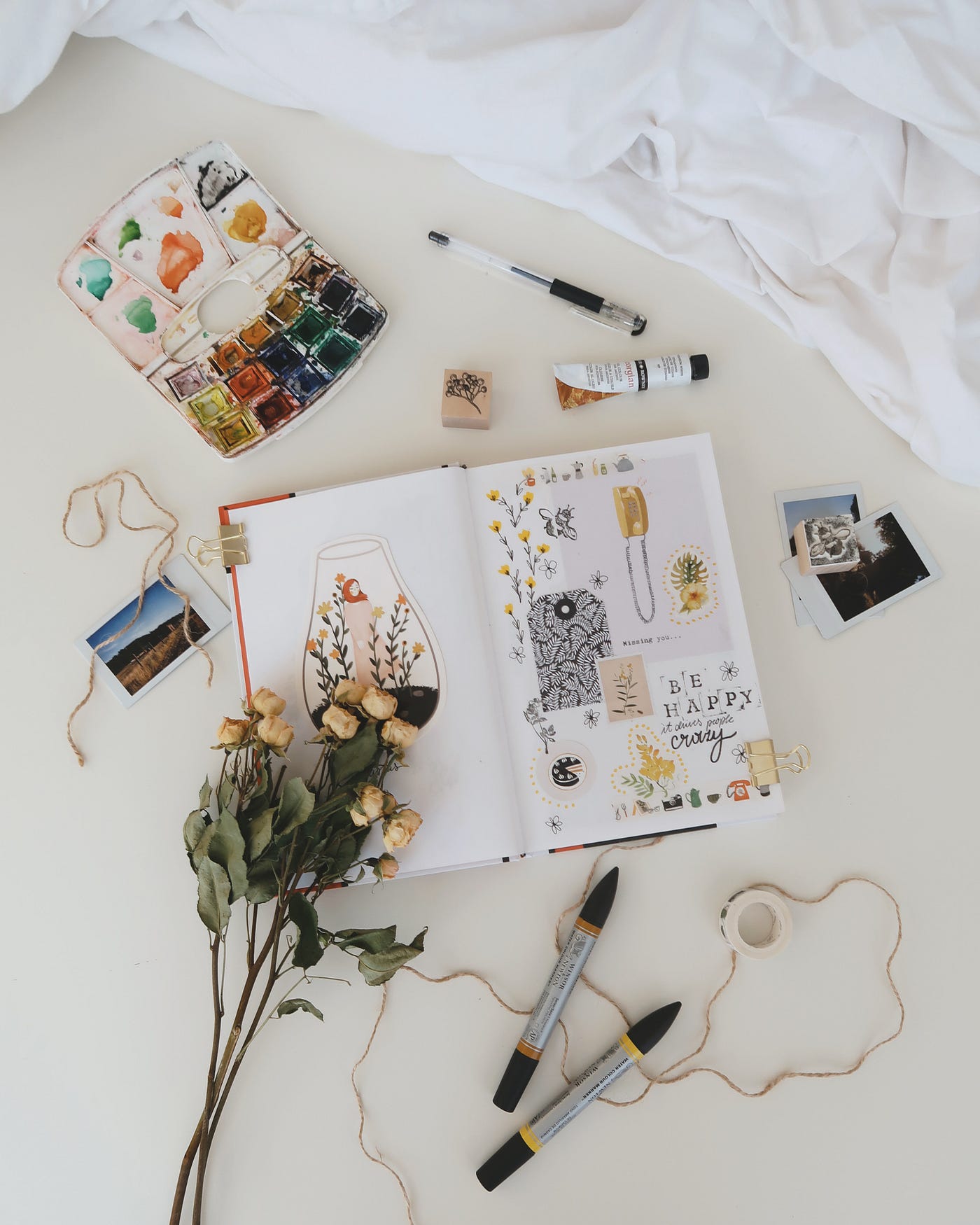 an aesthetic flat lay of junk journaling supplies gathered on top