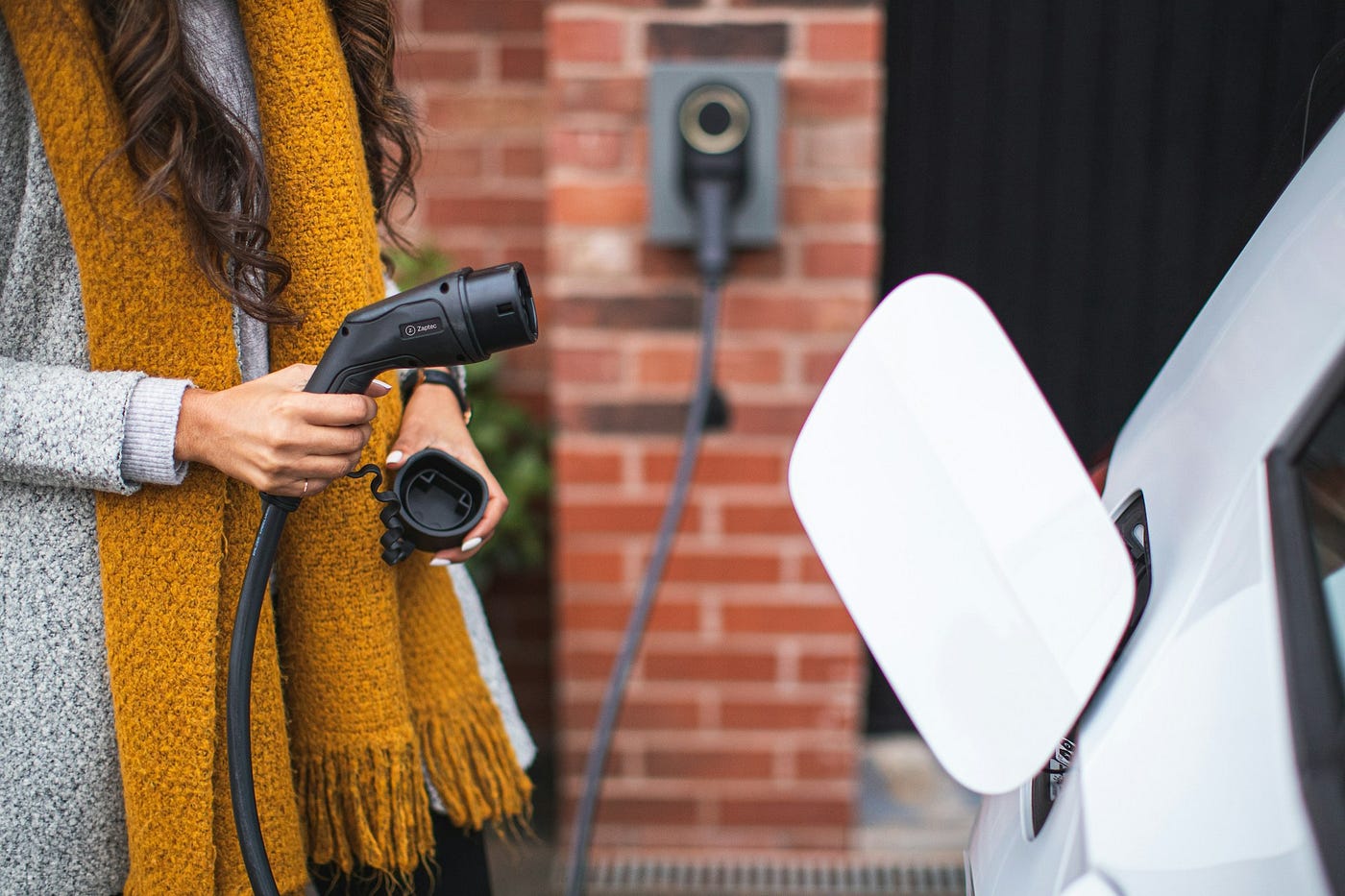 https://unsplash.com/photos/a-woman-is-pumping-gas-into-her-car-9166Worfn_Q @zaptec