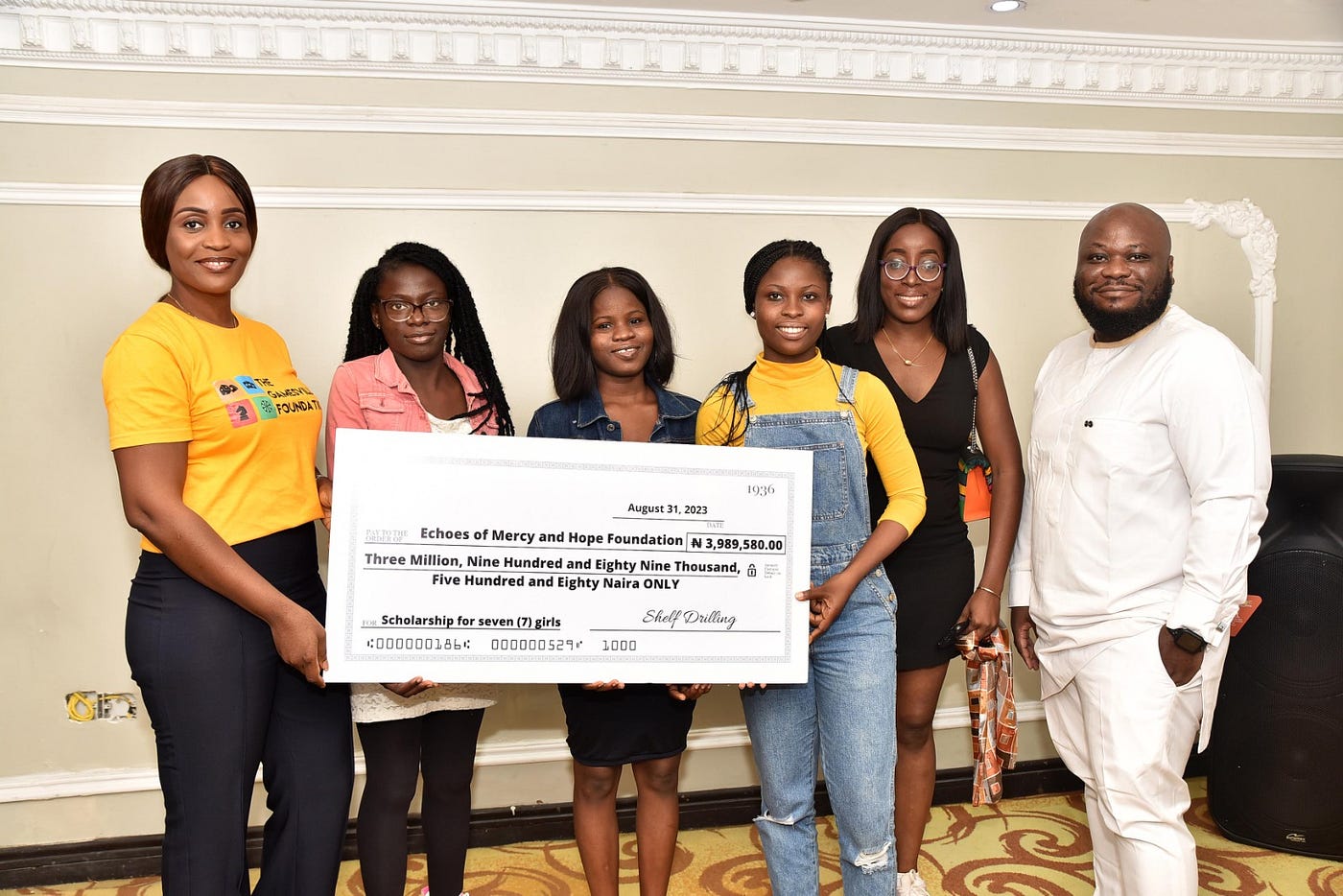 L-R; Njide Mariyln Okolo, Trustee, The Gamesville Foundation; Three (3) student scholarship recipients, Echoes of Mercy and Hope Foundation; Kolufunse Ajala, Trustee, The Gamesville Foundation; and Sijuade Oguntayo, Trustee, The Gamesville Foundation, during The Presentation Ceremony of Scholarships to eighteen underprivileged children in Lagos