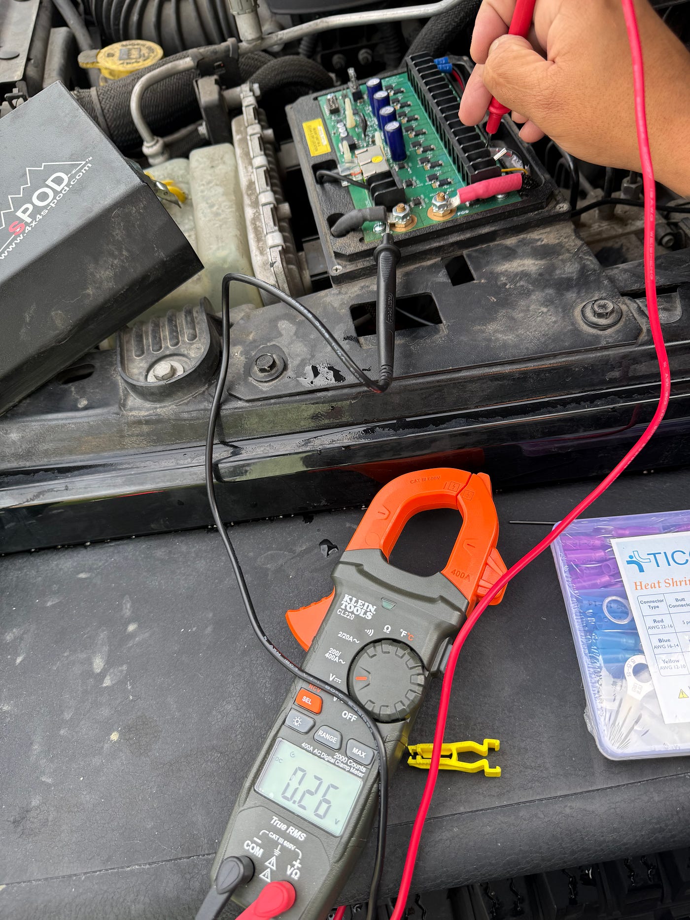 Multimeter displaying 0.26V with the test probes on the accessory board