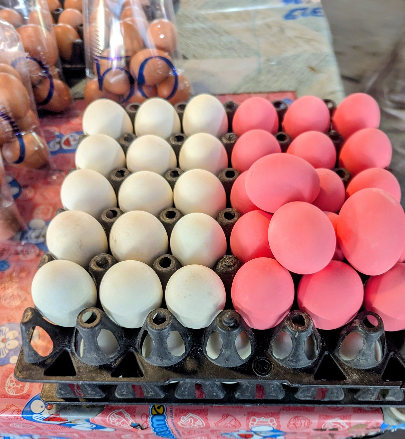 ไข่เยี่ยวม้า (khai yiao ma) which actually translates to “horse urine egg”. No urine is involved, horse or otherwise. The pink egg is the Thai variation of a century egg or thousand year old egg.