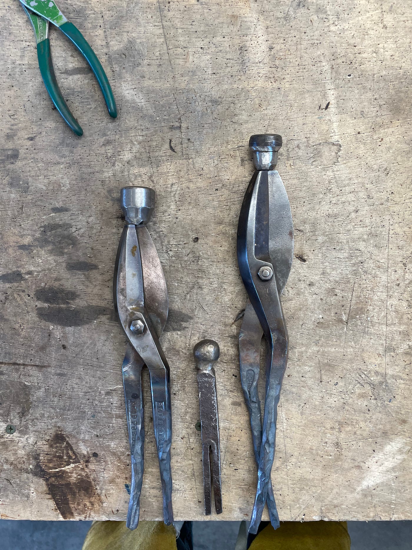 As a welded steel artist, I wanted to make something strong and lasting about their joy. Two tin snips, two hammer heads, a railroad spike.