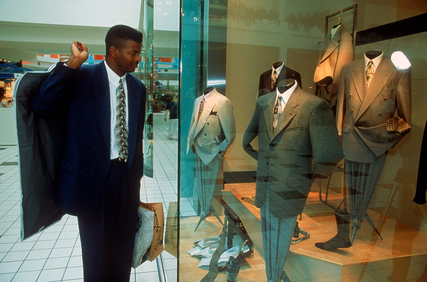 People walk past a window display at the luxury clothing store News  Photo - Getty Images