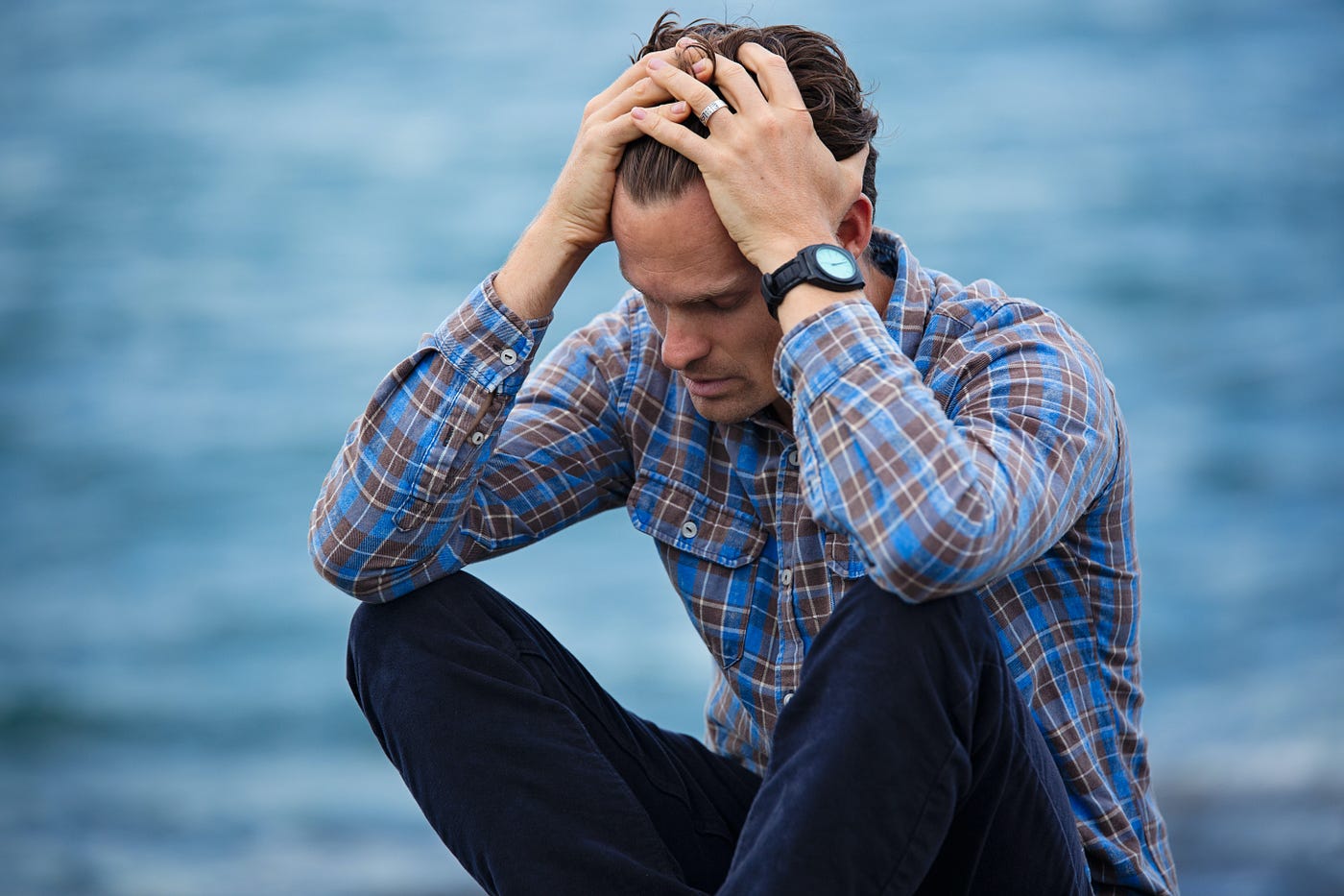 A man sitting in sorrow near sea