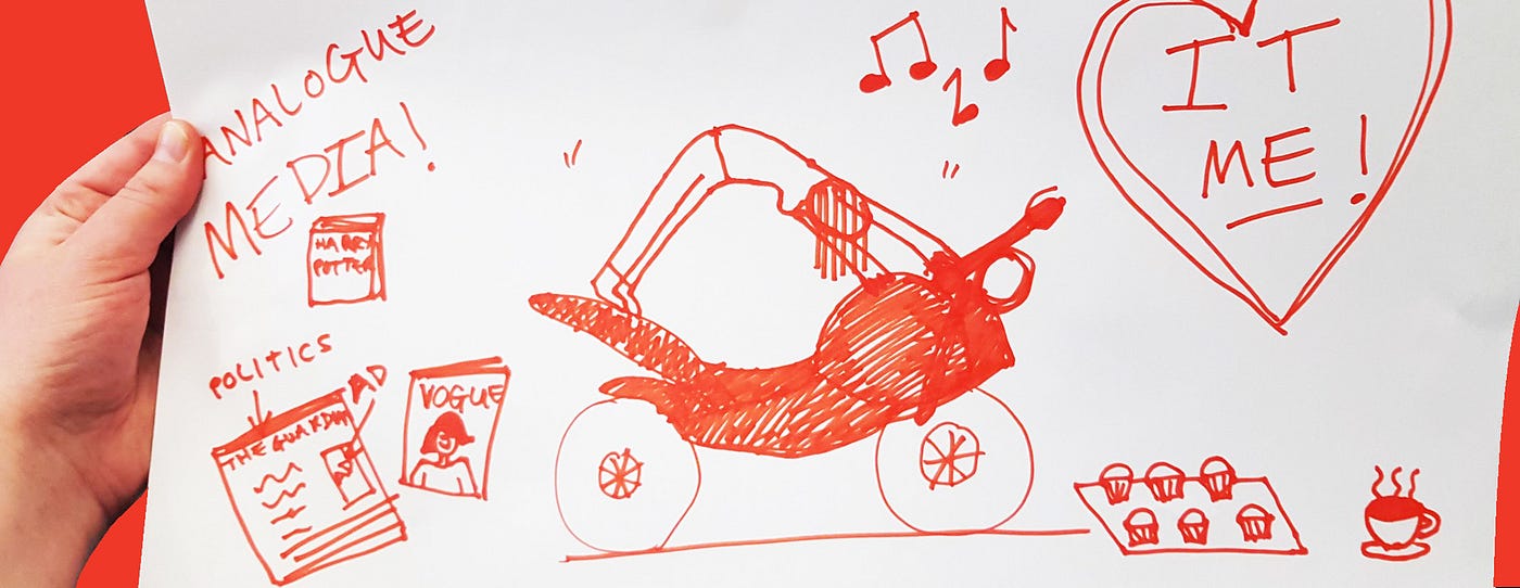 A hand holds a red illustration that shows a woman doing downward dog on a motorcycle. Artifacts are scattered around her