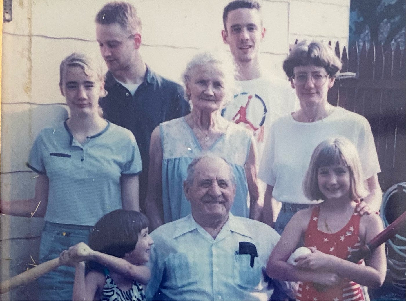 Author’s pic (a favorite one) with my two daughters left & right in the foreground, my sister middle right, her three kids & my mom in the middle. Dad with his glasses in his shirt pocket, front center. My daughter Jen (front left) looks like she was going to “bat” Grandpa a quick one — but she didn’t 😅