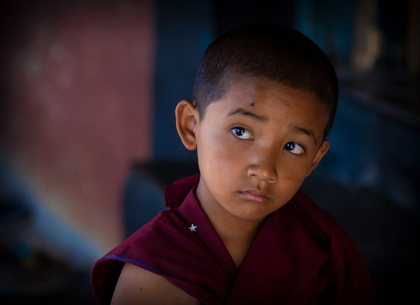Eyes full of wonder and wisdom beyond years — a moment of childhood in Ladakh captured by Arun Saha Photography.