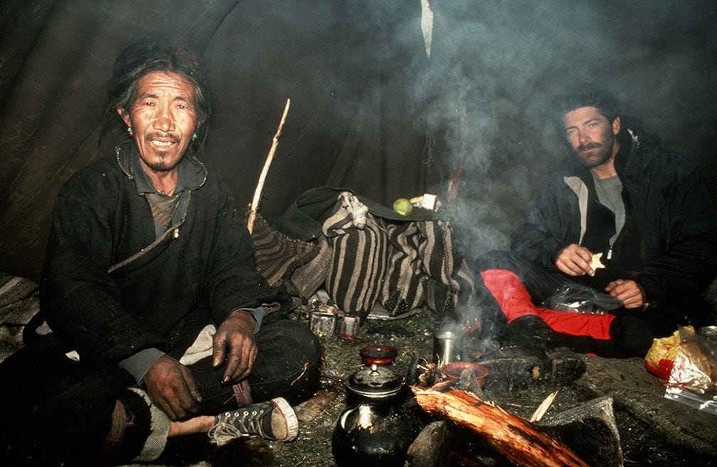 disaster home cook at kitchen- young funny and desperate man in cooking  apron holding pot in flames in stress and fear making a mess of fire and  smoke with food burning Stock