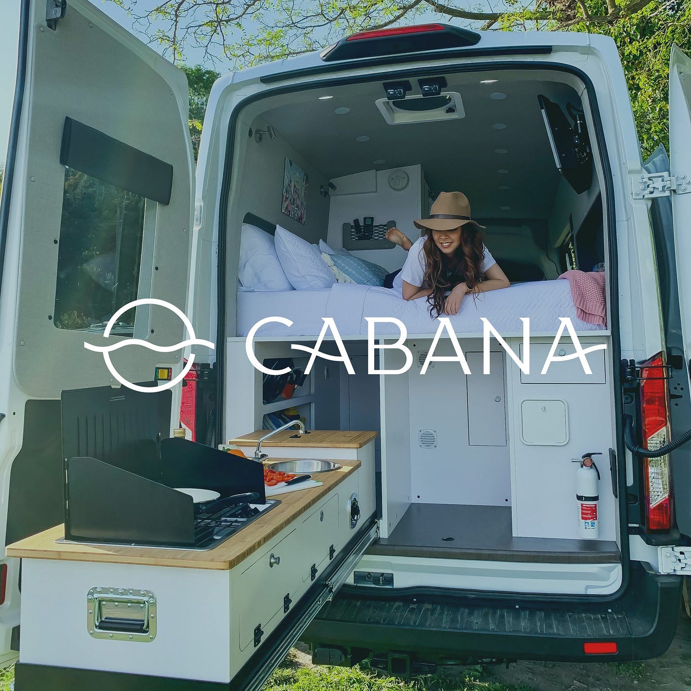 Ad for a Cabana vehicle with its back doors open, showing someone on a loft bed, looking at a pullout desk below.