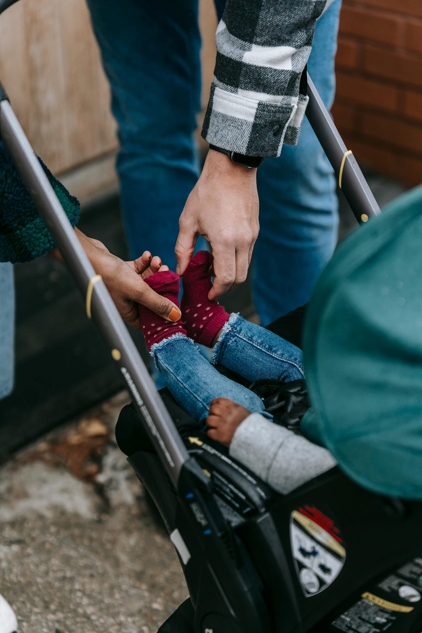 credit/Photo by William Fortunato : https://www.pexels.com/photo/crop-multiracial-parents-with-baby-in-stroller-6393393/