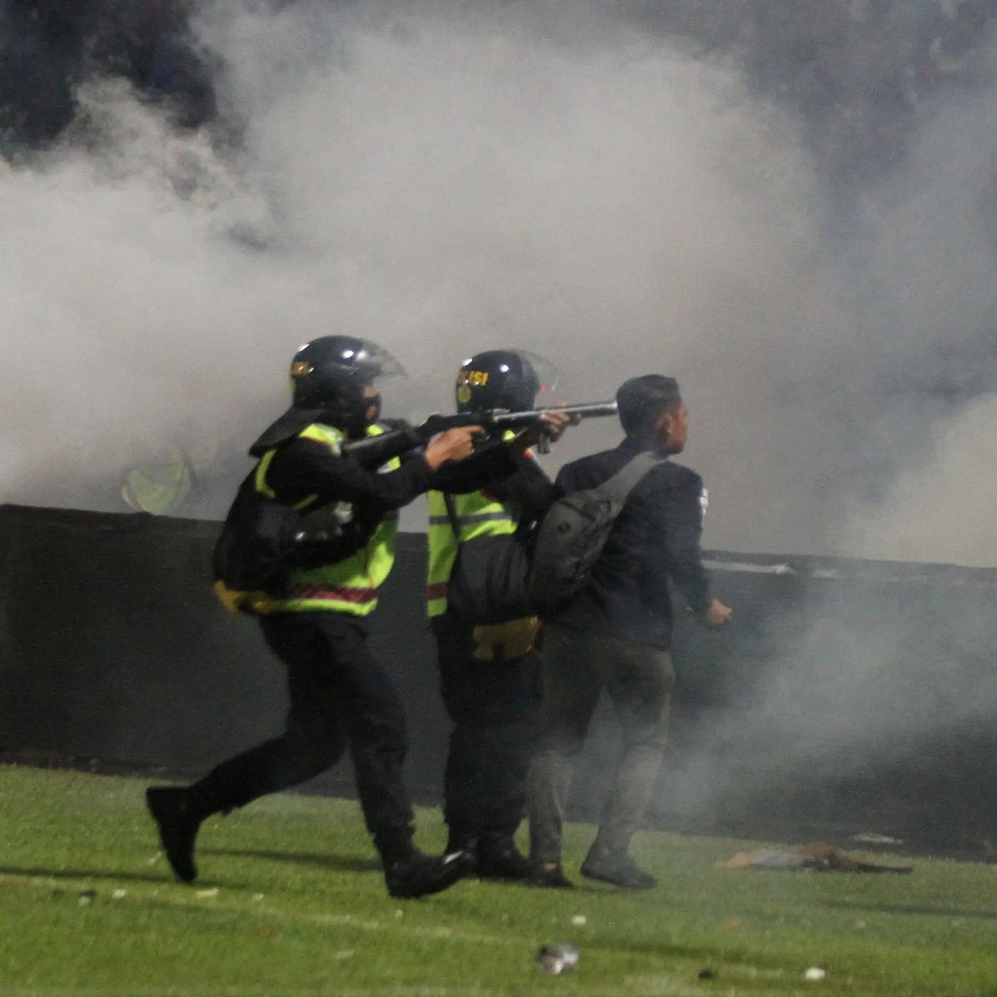 A riot police officer fired tear gas at Kanjuruhan Stadium, Malang, East Java province, Indonesia, on Sunday. Credit Foto/Via Reuters