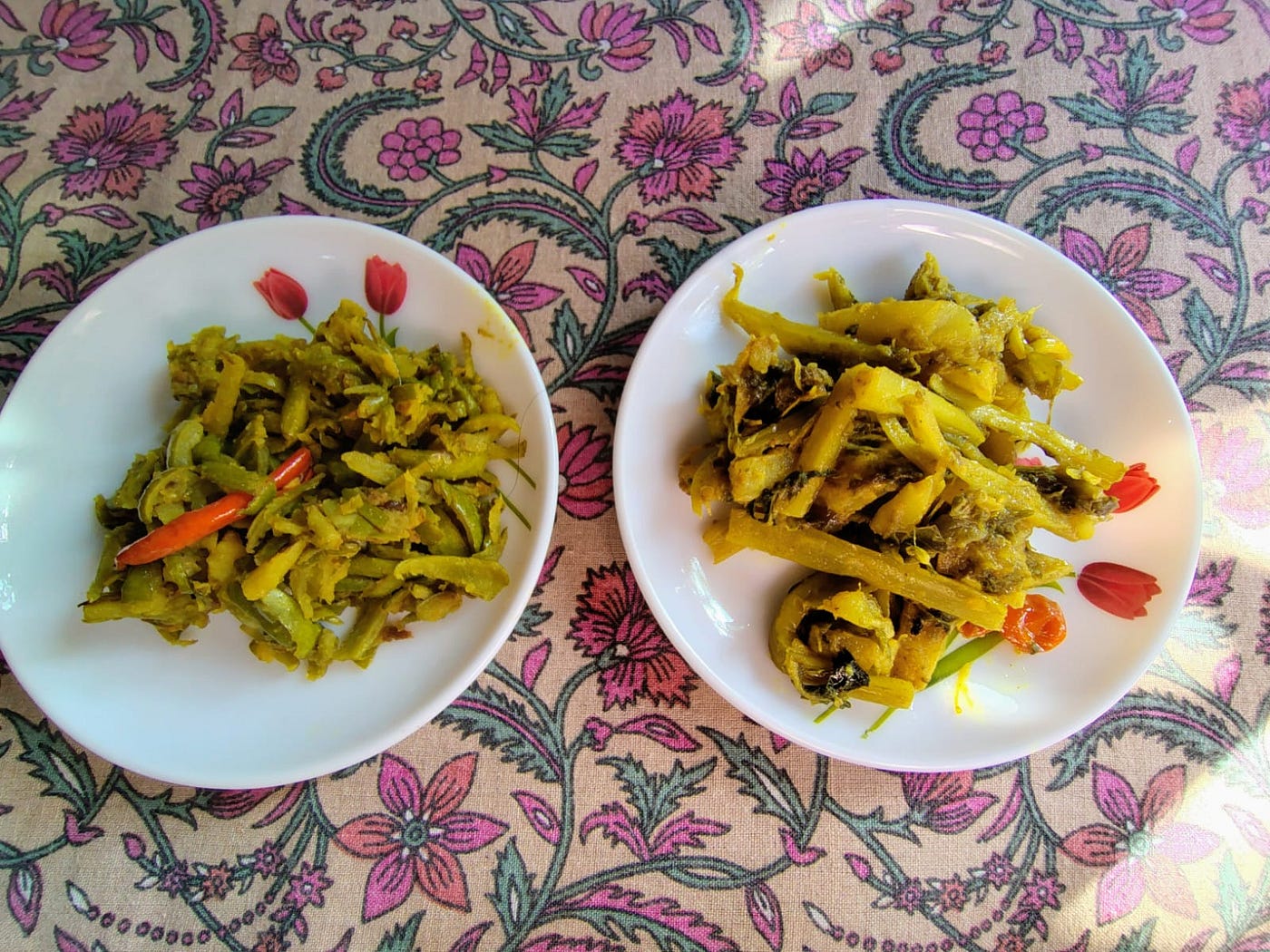 On the left we have Lau kosha bhaja (bottle gourd’s skin stir fry) and (on the right) califlower’s stems and leaves stir fry — photo by the author.