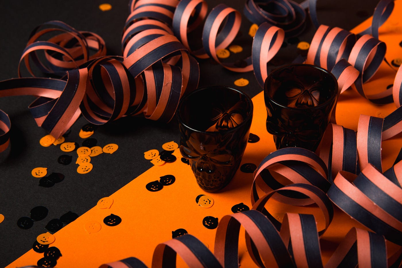 black and orange confetti on orange paper with ornage and black paper spirals