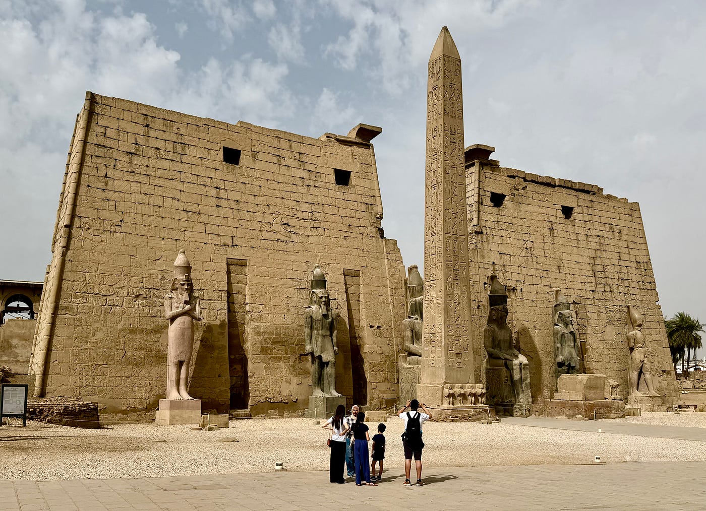 The pylon entrance towers of Luxor Temple are flanked by statues of Rameses II and one of a pair of obelisks. The other is in Paris. Photo: David A. Laws