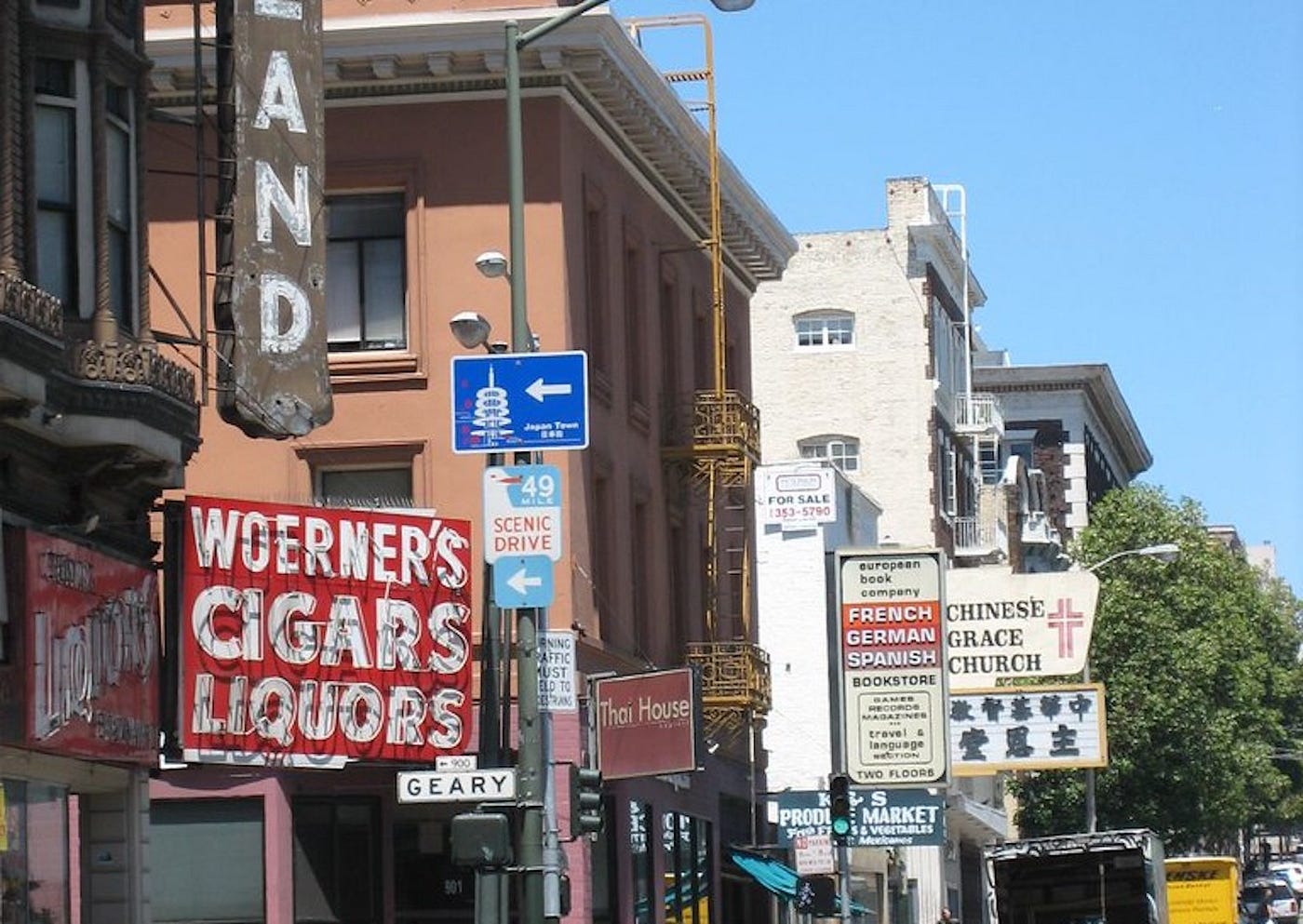 Woerner’s Cigars and Liquors in the foreground and other SF shops along the street.