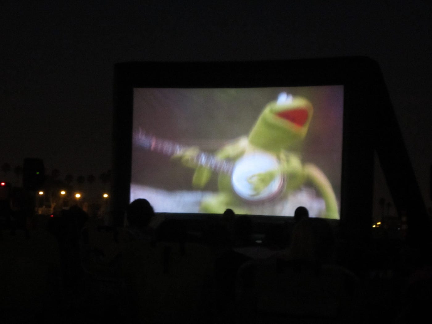 An out of focus shot of a movies-at-the-beach screening of The Muppet Movie | Photo by author
