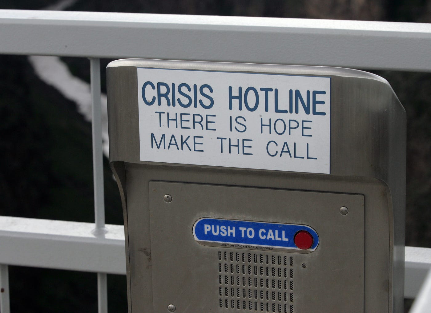 A metal callbox that says “Crisis hotline: There is hope. Make the call.” Then a “Push to call” button.