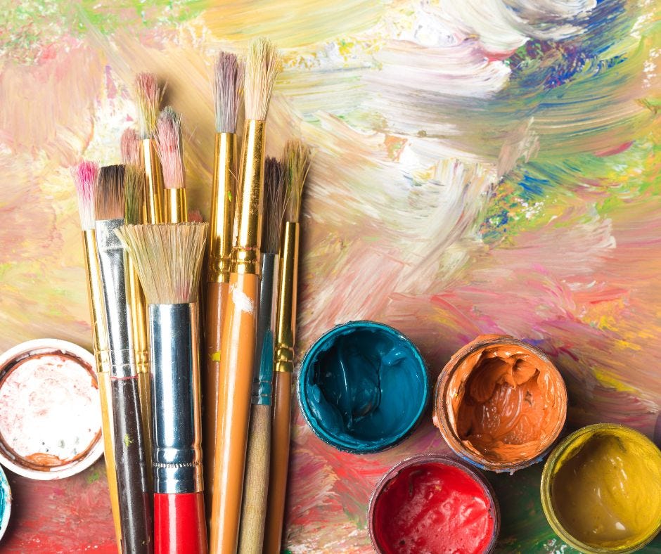 A colorful painting palette with brushes and paints.