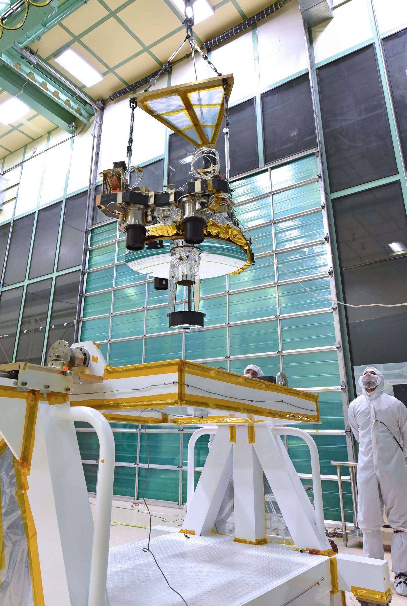 Integration activities inside the Spacecraft Checkout and Integration Area (SCA) clean room at Goddard Space Flight Center. We can see GEDI’s 80 cm telescope through which the received light is collected. (Public domain)
