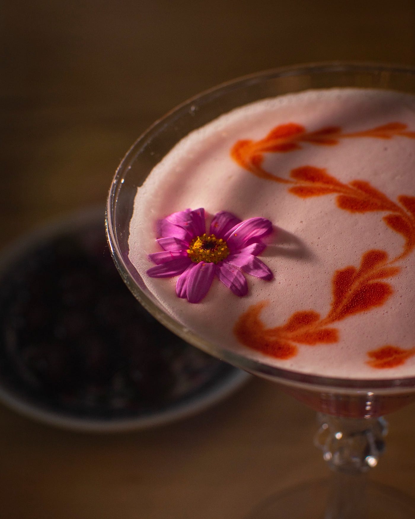 Tequila mockingbird garnished with edible flowers and dehydrated