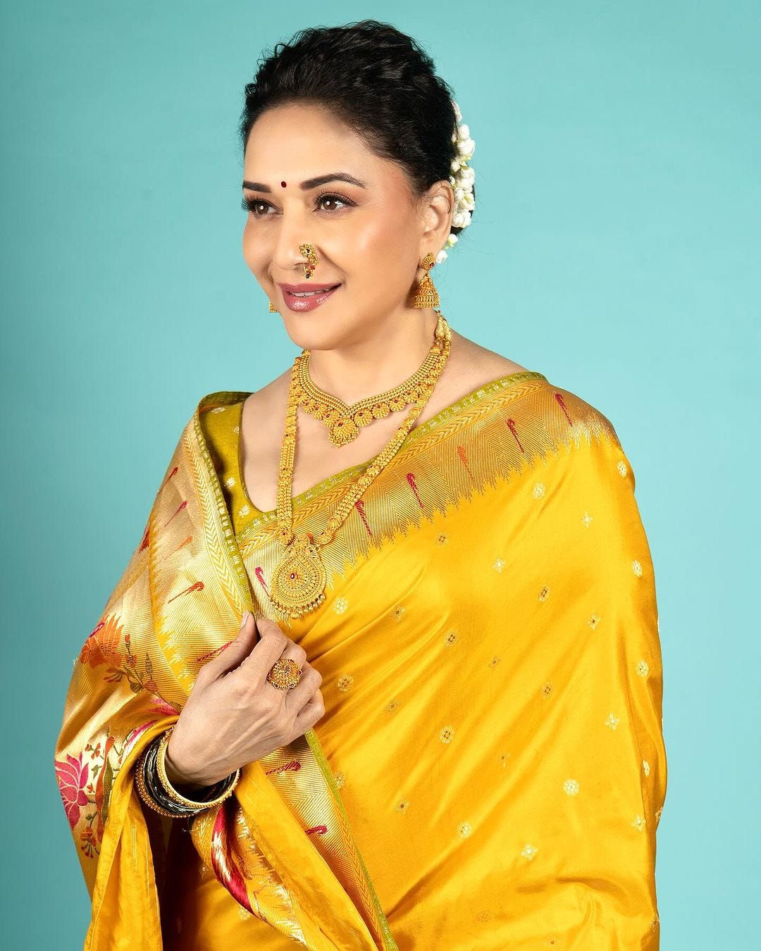 Embracing Elegance: Madhuri Dixit Shines in Sacred Weave's Yellow