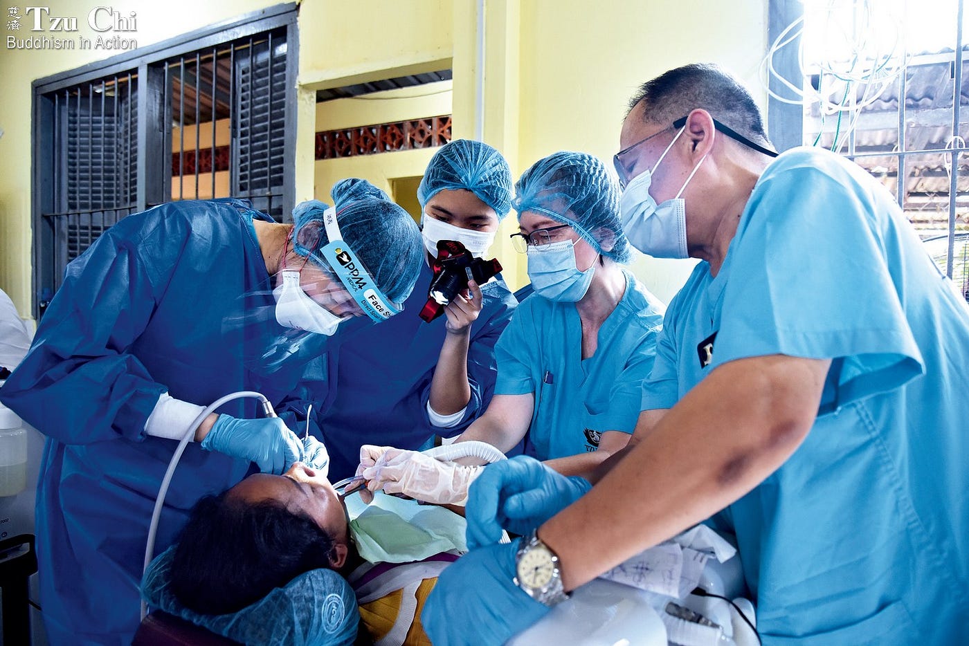 One dentist performs the treatment as others assist with suction, lighting, and other supportive tasks. (Chai Mong Ping)