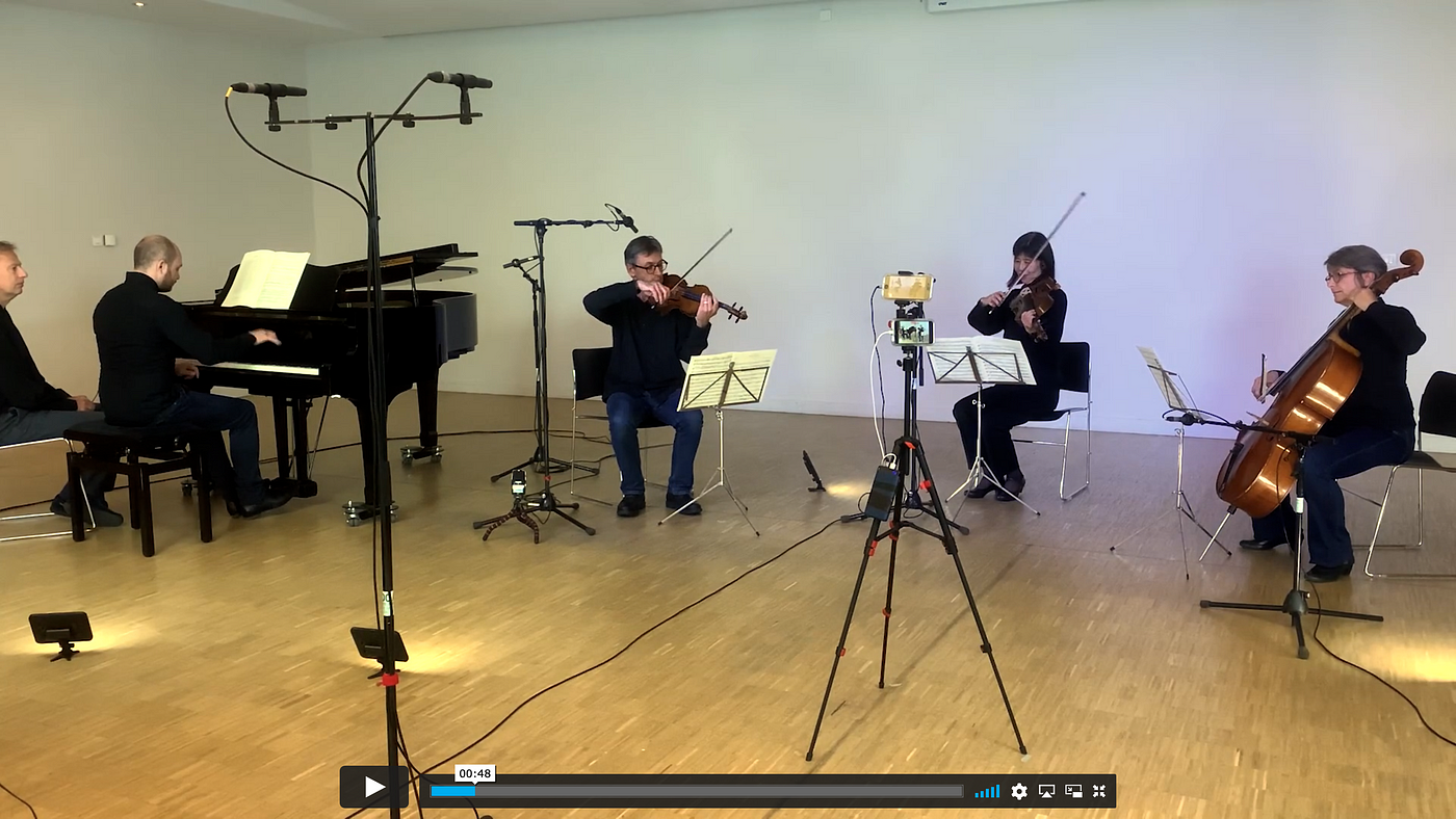 A piano quartet in an unusual setup, all in a semicircle including the piano, which is usually behind