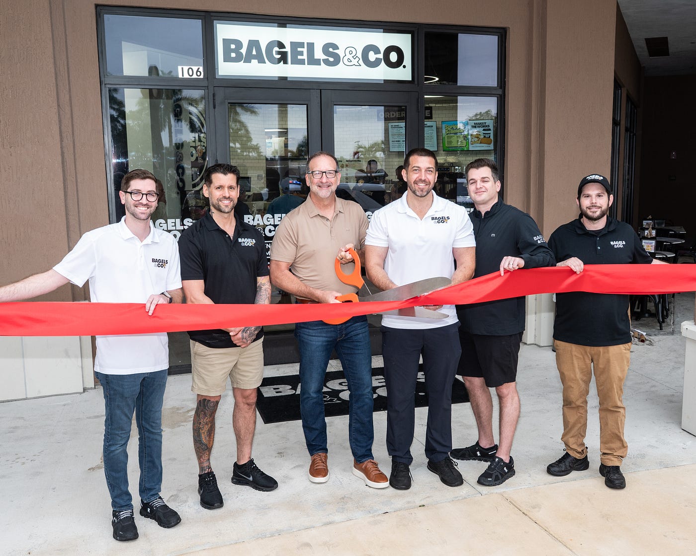 (left to right) Mark Kaplan, Matthew Hoffman, Kevin Armantrout, Matthew Driscoll, David Kaplan and Samuel Chalom at the Bagels & Co. ribbon cutting in Davie. (Credit: Michael Murphy)