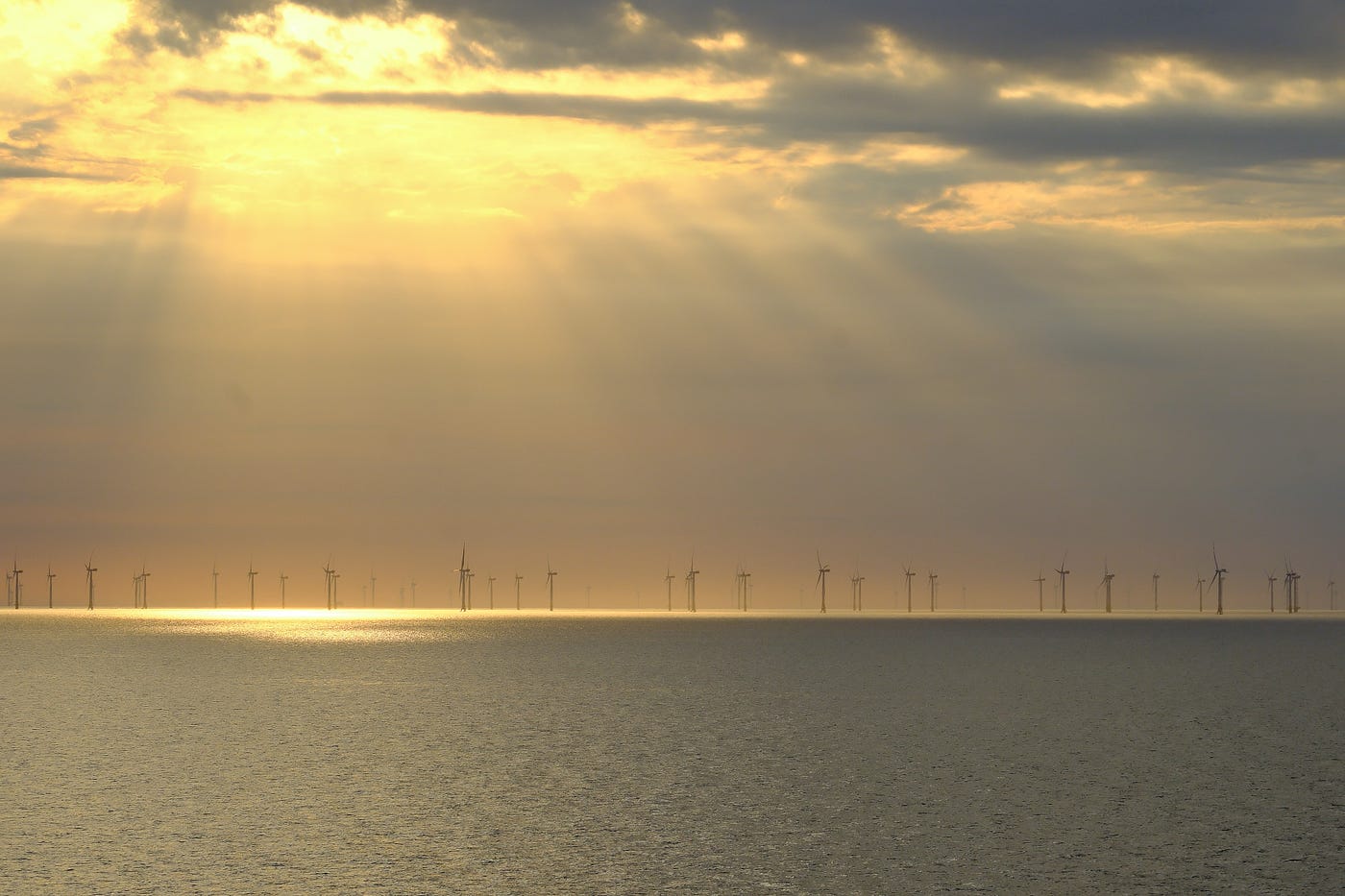 The sun casts golden light over an offshore wind farm in the Baltic Sea. All photos credited to the author: Alex Marie White.