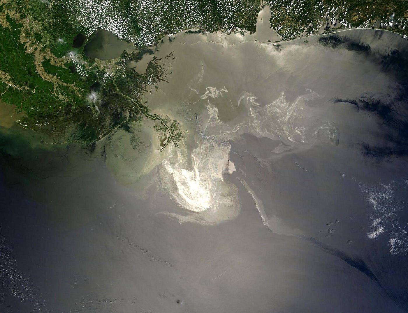 The oil spill caused by the accident on the Deepwater Horizon oil rig, as seen by NASA’s Terra satellite on May 24, 2010. Public domain