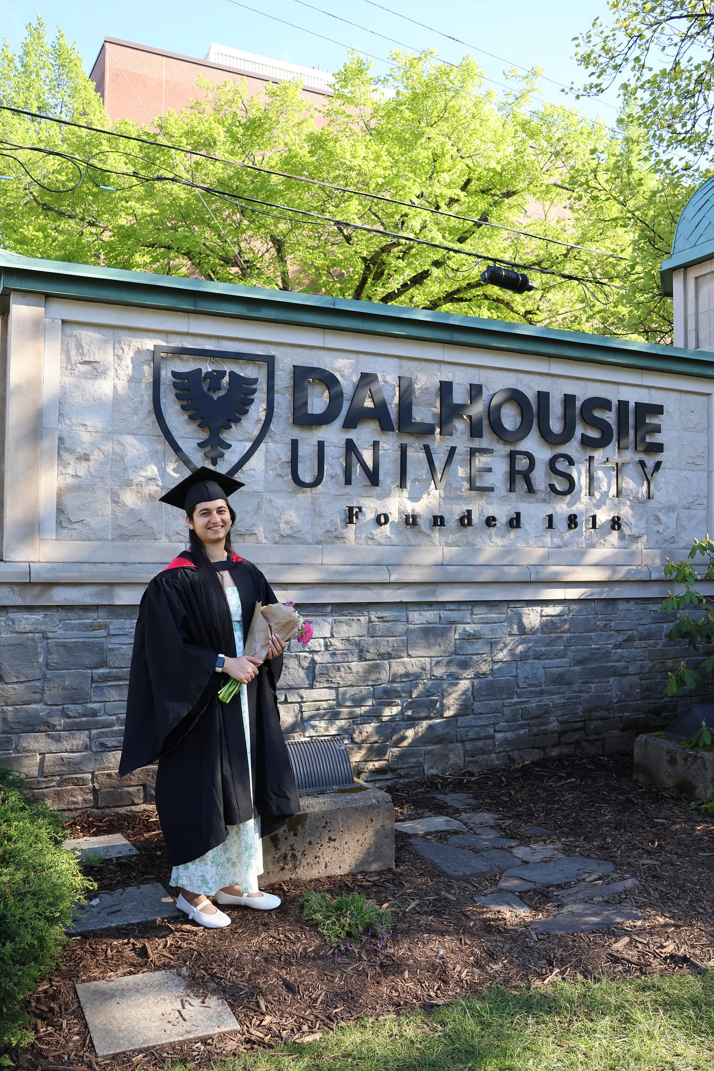 Anita’s convocation portrait at the university sign