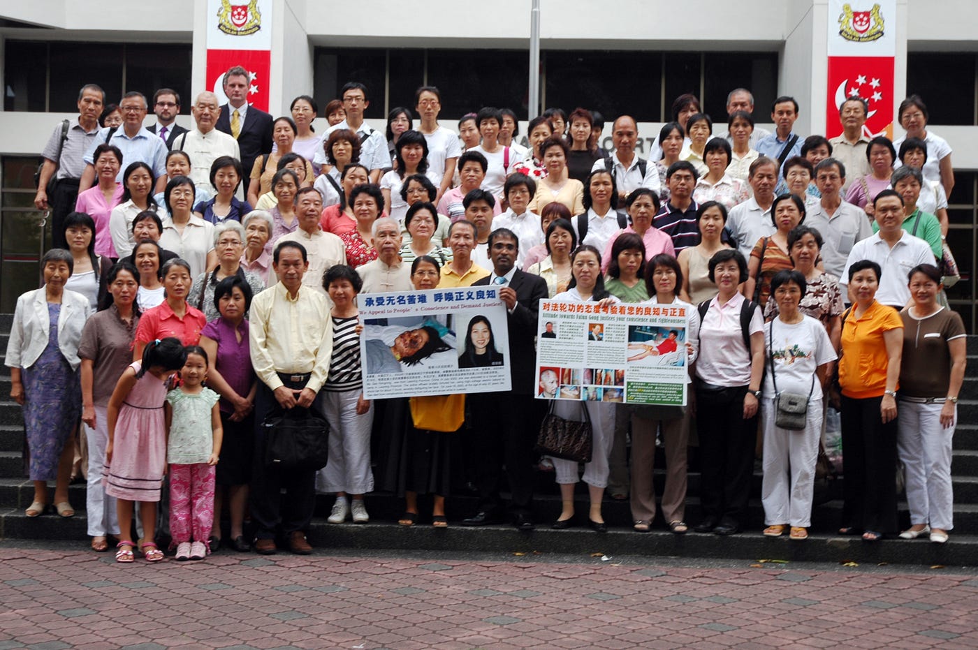 Local Falun Gong practitioners gather with M Ravi outside the High Court, Singapore.