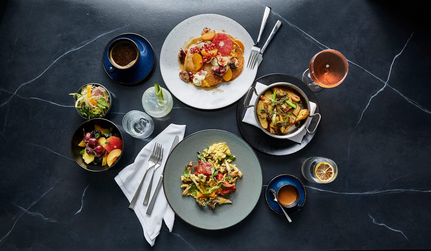 Various dishes arranged artfully on a dark background.