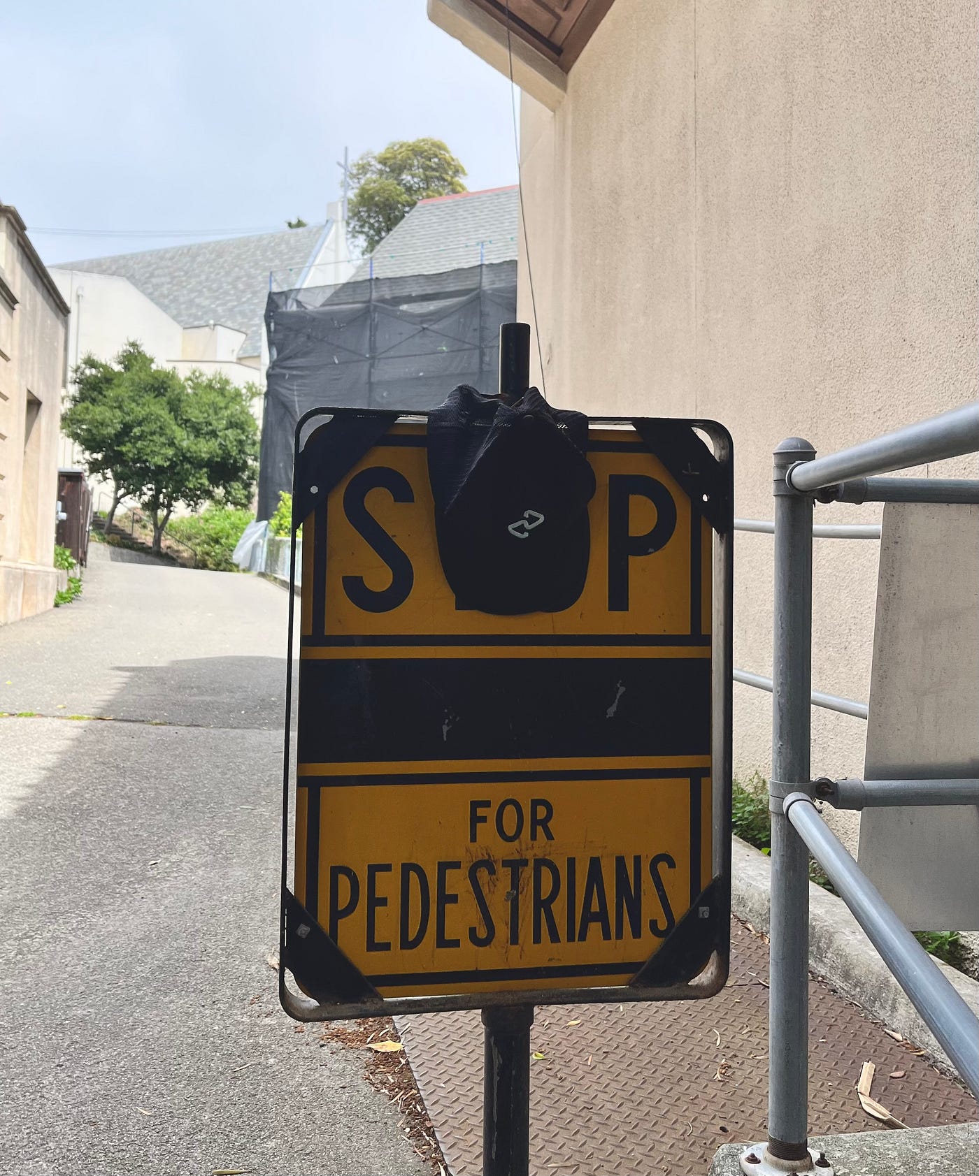 Hat with the Afterpay logo hanging on a street sign.