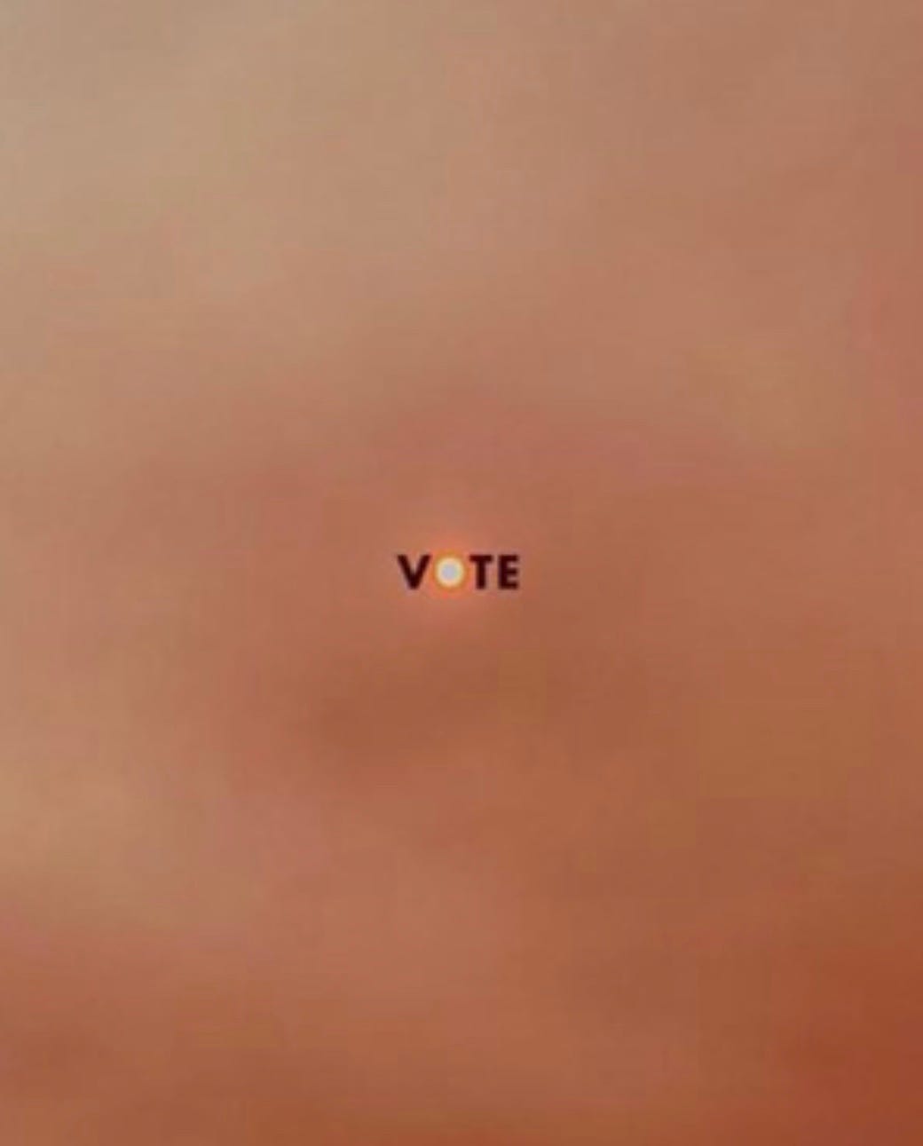 A photo of a smoky orange sky is overlaid with the word “Vote,” framing a muted sun in the center of the image.